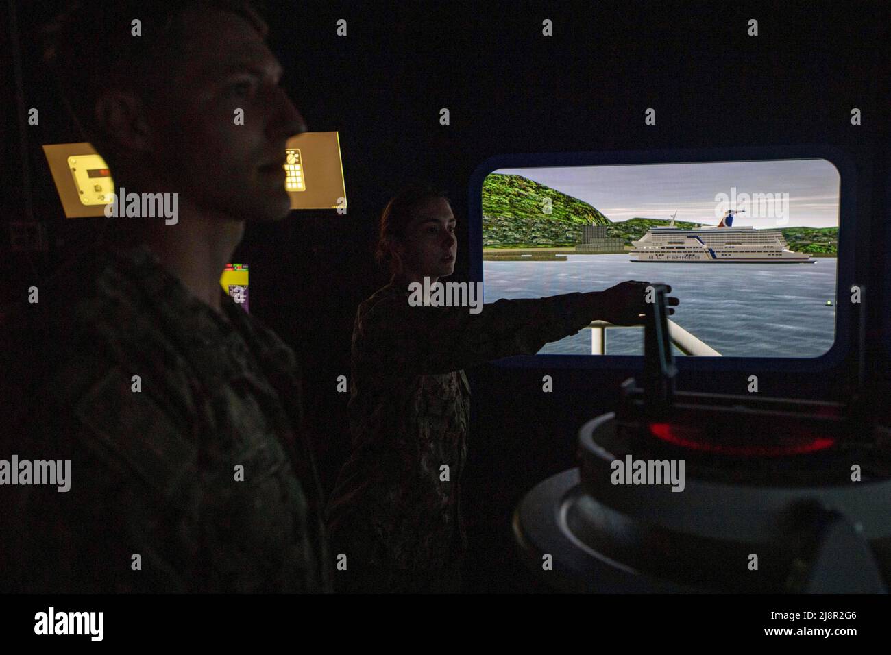 May 4, 2022 - Sasebo, Japan - Ensign Catherine Depuy, right, from San Francisco, assigned to the forward-deployed amphibious assault ship USS America (LHA 6), acts as a navigation evaluator during training inside a Navigation, Seamanship, and Ship Handling Training simulator. America, lead ship of the America Amphibious Ready Group, is operating in the U.S. 7th Fleet area of responsibility to enhance interoperability with allies and partners and serve as a ready response force to defend peace and stability in the Indo-Pacific region. (Credit Image: © U.S. Navy/ZUMA Press Wire Service/ZUMAPRESS Stock Photo