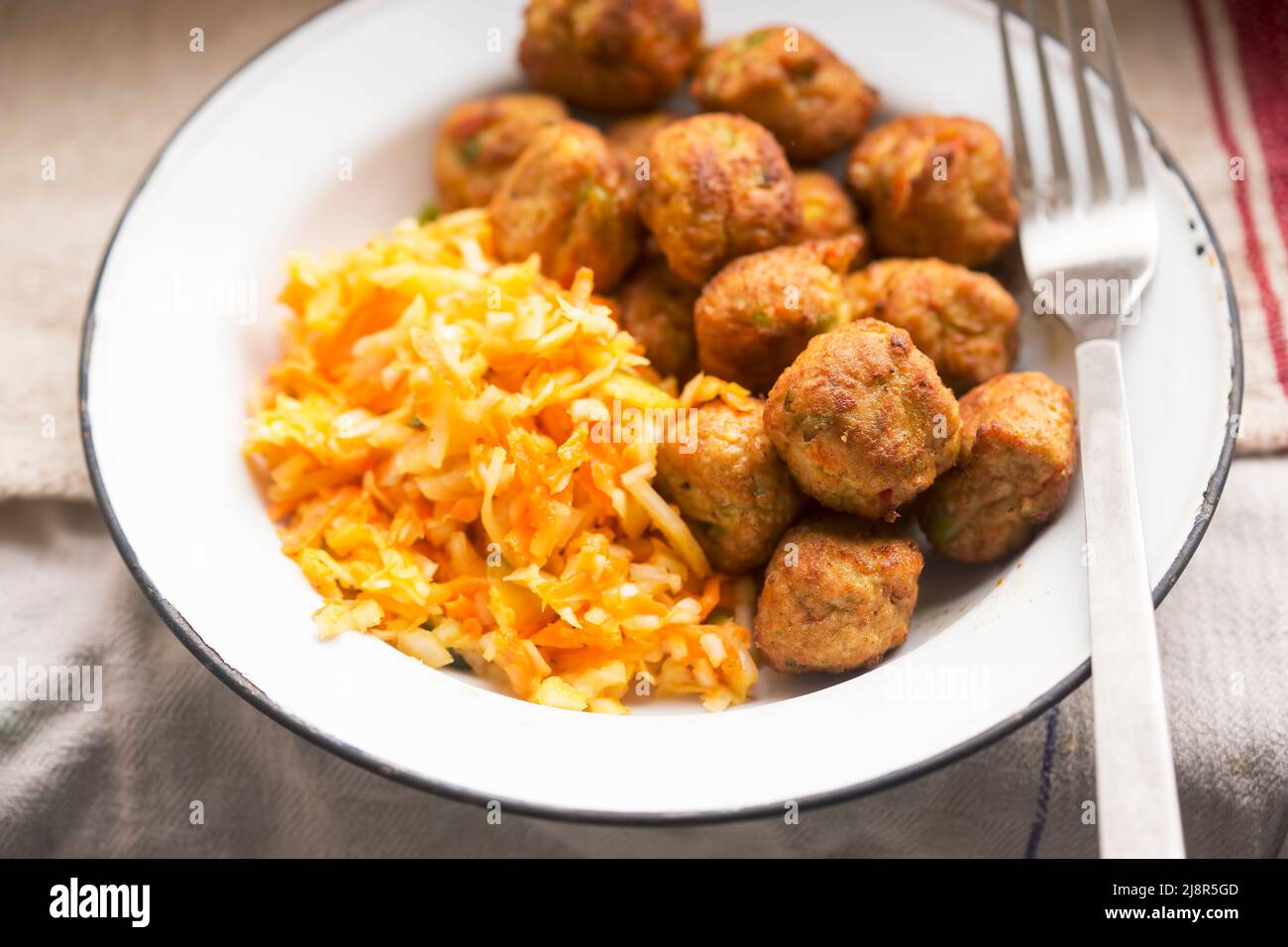 Vegetarian soy (meat alternative) carrot and peas balls with cabbage