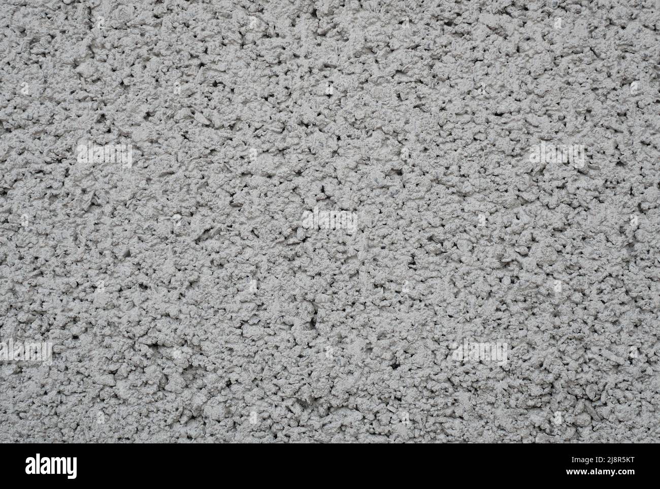 The rough and porous texture of the gray concrete wall, Black and white abstract background Stock Photo