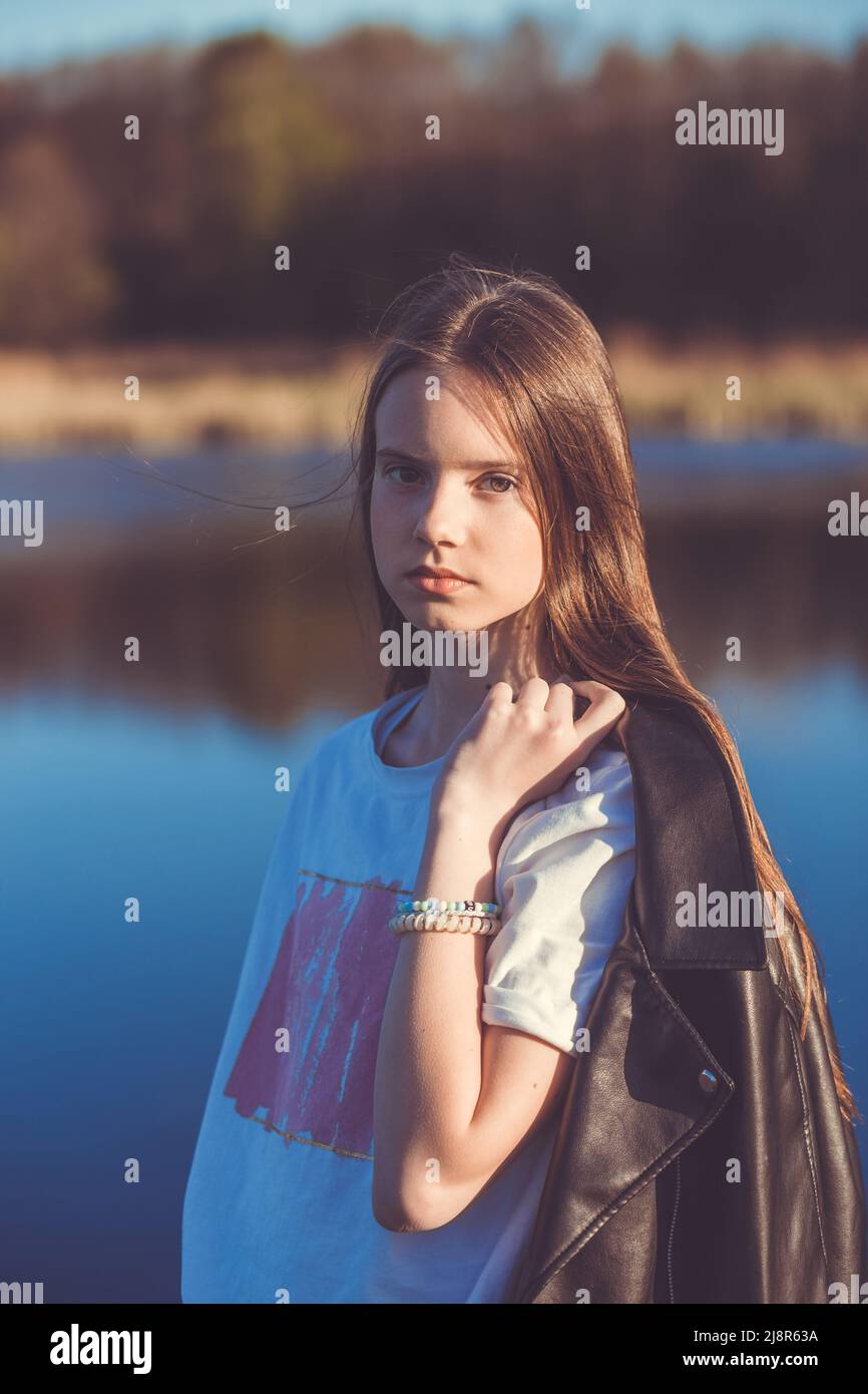 Portrait of a beautiful happy teenage girl outdoors in spring. A girl ...