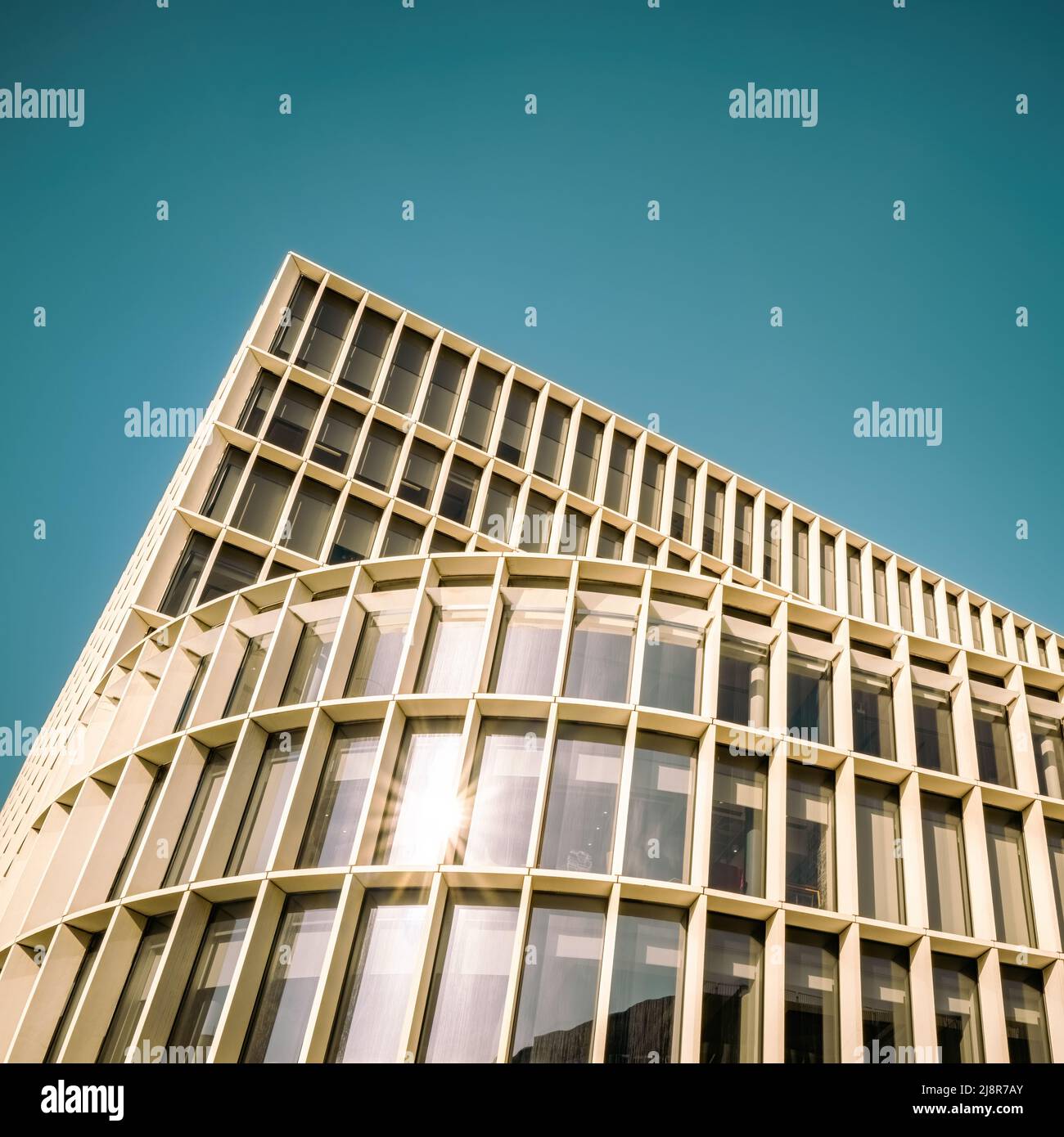 Modern architecture detail. Toned image with sunburst, with space for text. Stock Photo