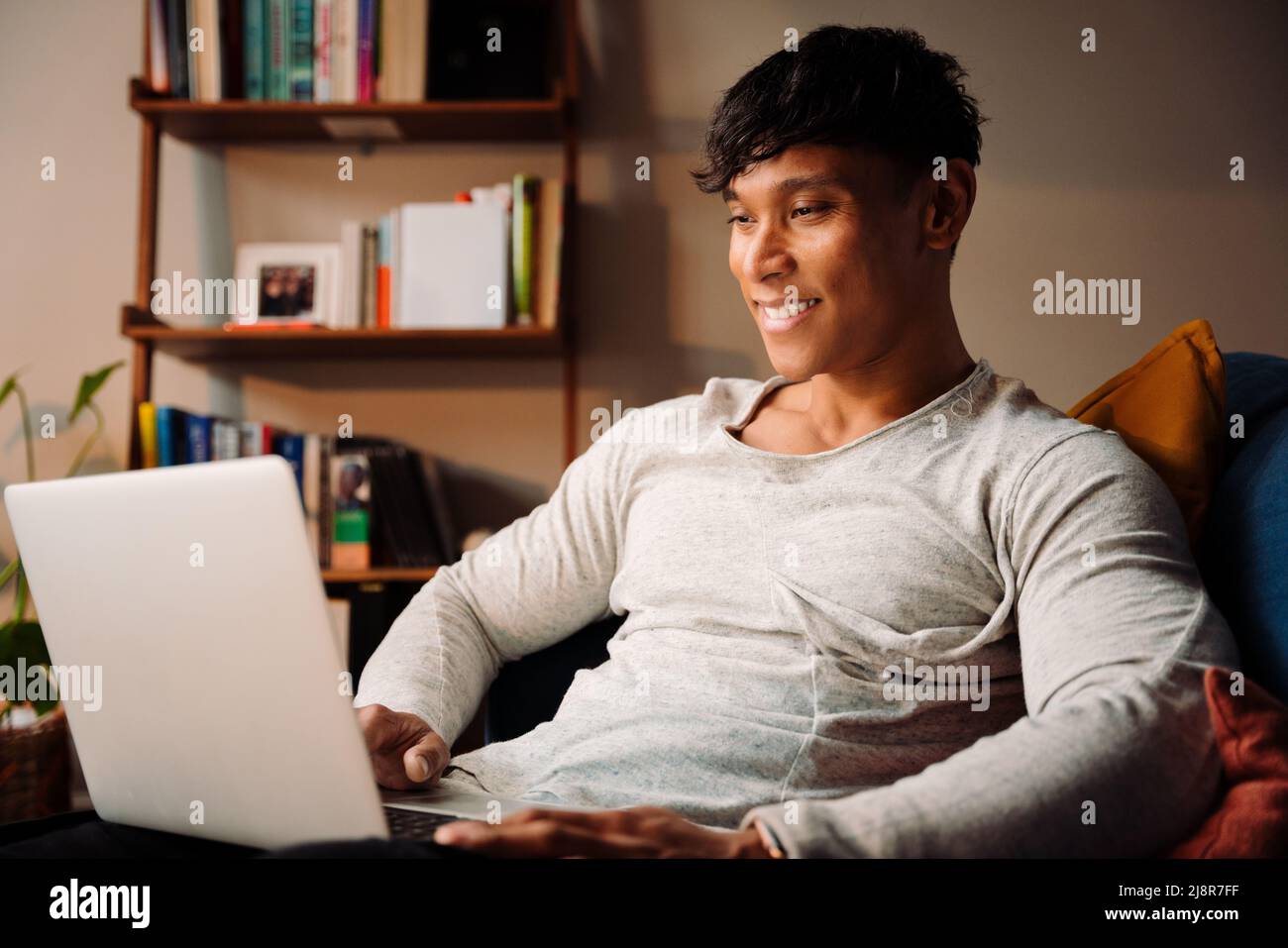 Asian male working on laptop at home Stock Photo