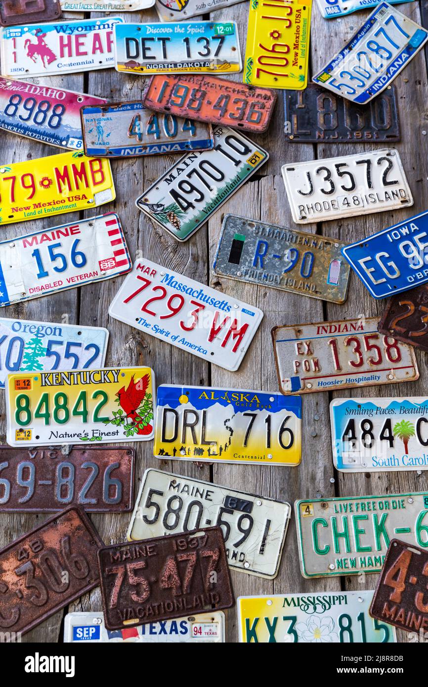 Bar Harbor, Maine, USA - August 28 2014: Old car license plates on a wall in Bar Harbor. In the United States, each jurisdiction has a unique design, Stock Photo