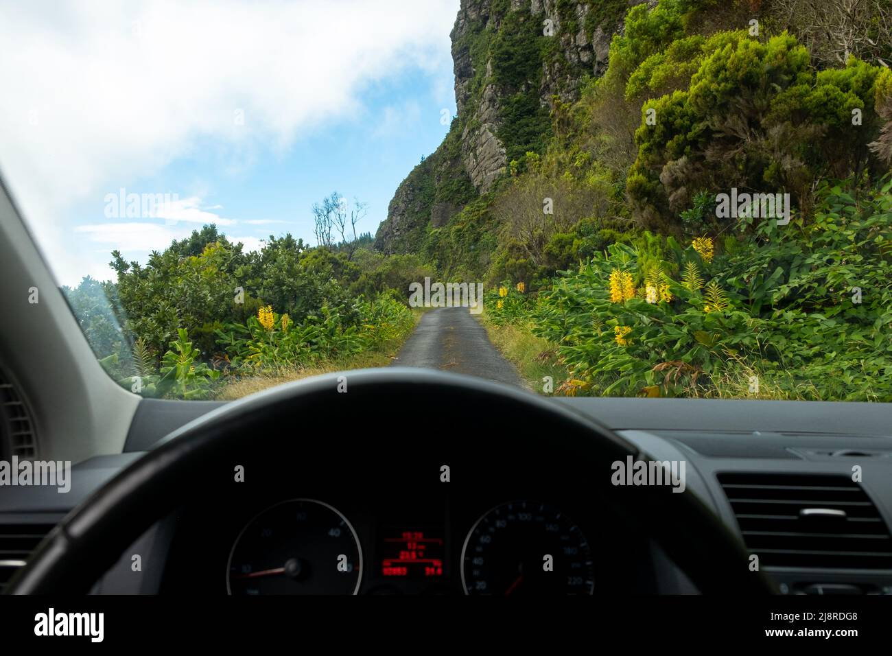 View from inside car windshield with dashboard view over a secondary traditional road in Lombadas Springs, on the island of Sao Miguel, Azores, Portug Stock Photo
