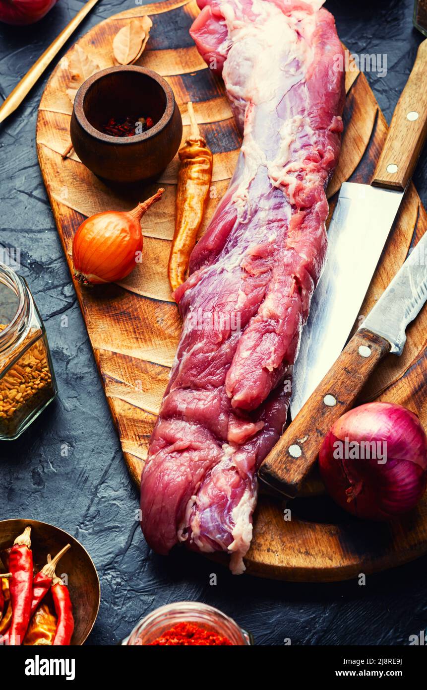 One piece of fresh raw pork tenderloin and spiced ingredients Stock