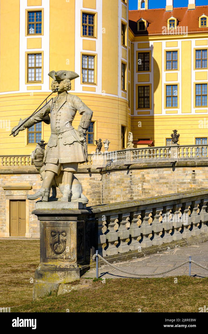 Moritzburg Palace in Moritzburg near Dresden, Saxony, Germany: Statue of a hunter with dog in front of the main ramp on the South side of the palace. Stock Photo