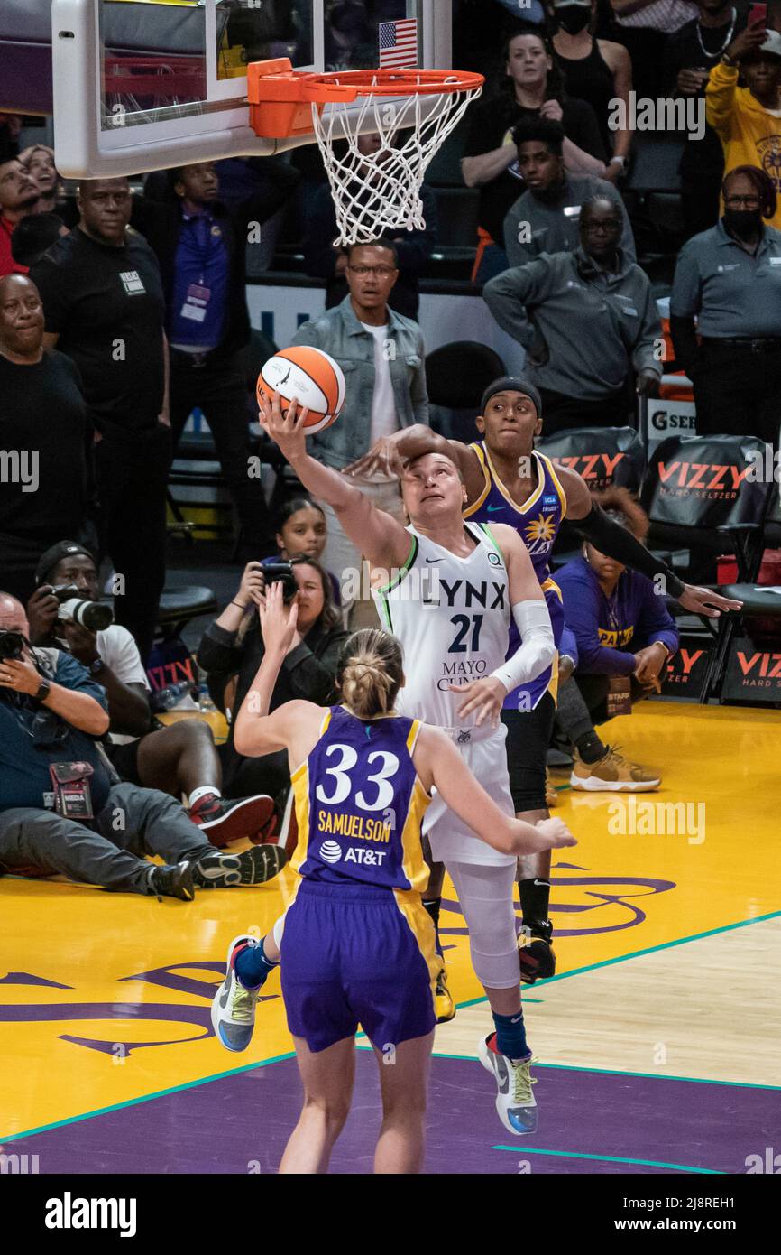 Minnesota Lynx guard Kayla McBride (21) scores the game winning field goal  and is fouled by Los Angeles Sparks guard Brittney Sykes (15) to complete a  three point play during a WNBA