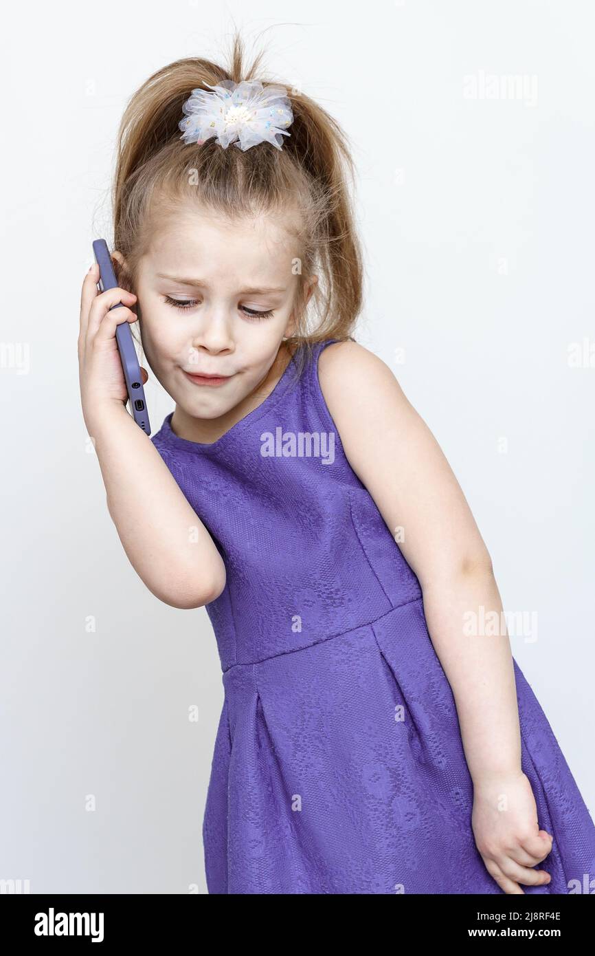 cute 56 year old girl in a blue dress posing in the studio with a