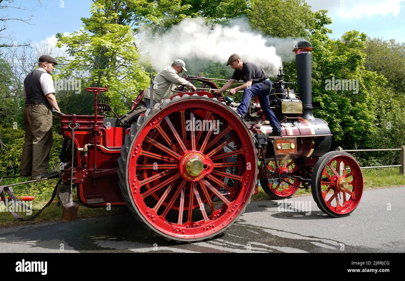 People work on the Foden General Purpose Engine 3384, 'Wattie Pollock' as it stops to take on water in Kimbridge, Hampshire, whilst it travels to the Mid Hants Railway, also known as the Watercress Line, to take part in their Vintage Vehicles weekend which runs from 20-22 May. Stock Photo