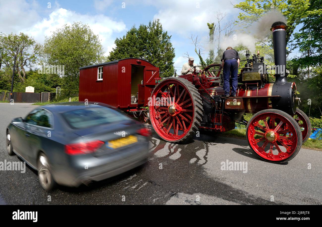 People work on the Foden General Purpose Engine 3384, 'Wattie Pollock' as it stops to take on water in Kimbridge, Hampshire, whilst it travels to the Mid Hants Railway, also known as the Watercress Line, to take part in their Vintage Vehicles weekend which runs from 20-22 May. Stock Photo
