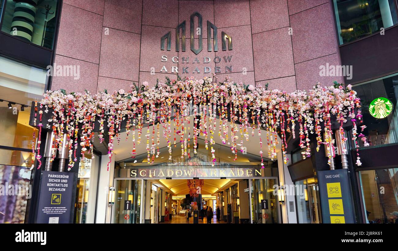 Entrance of the shopping mall 'Schadow-Arkaden' in Düsseldorf/Germany with colourful Spring flower decoration. Stock Photo
