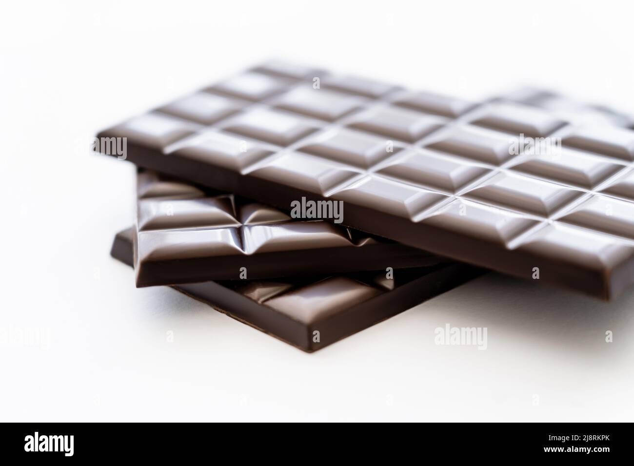 Close up view of bars of dark chocolate on white background Stock Photo ...