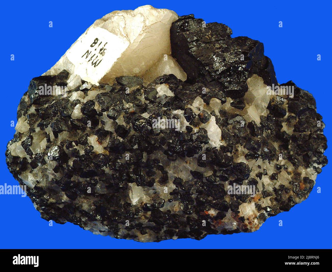 Zincite and franklinite. The red in this sample is zincite, ZnO
