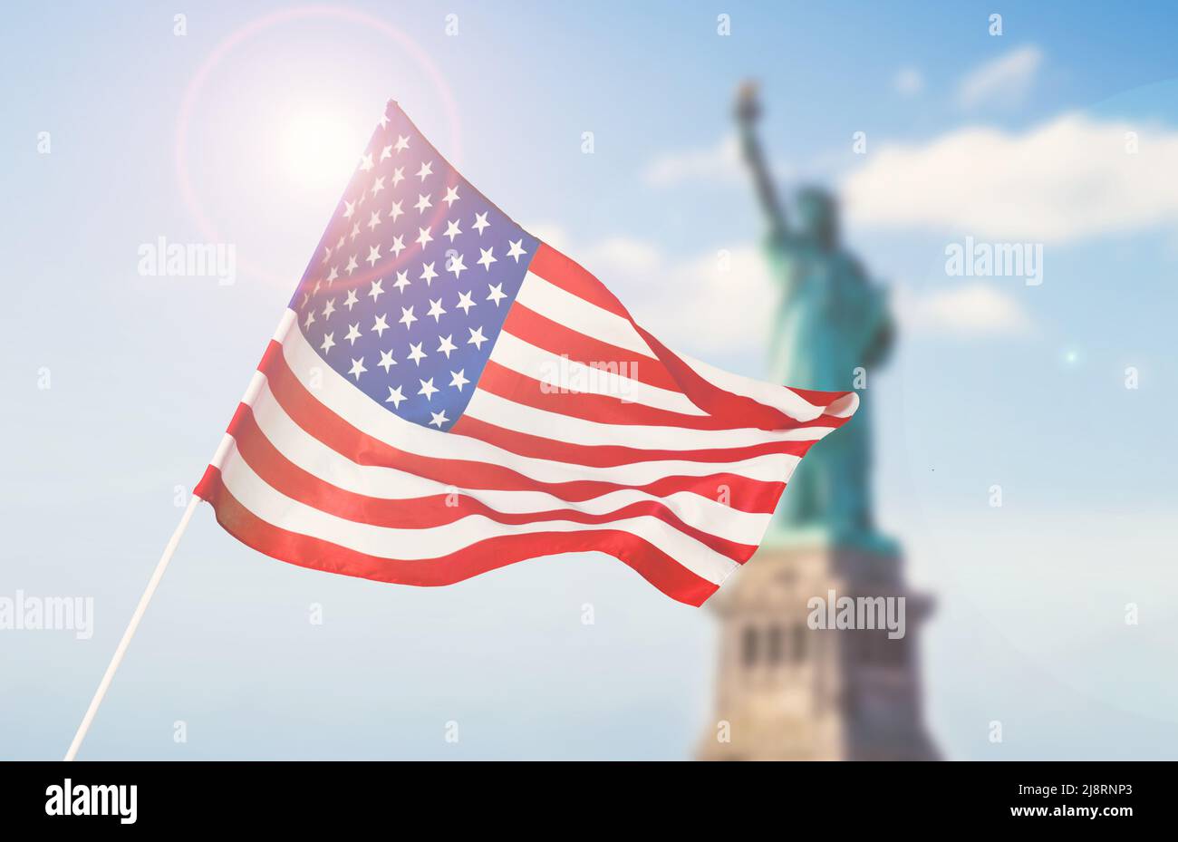 American flag on blurred statue of liberty background for Memorial Day, 4th of July, Labour Day, Presidents Day, Independence Day. Stock Photo