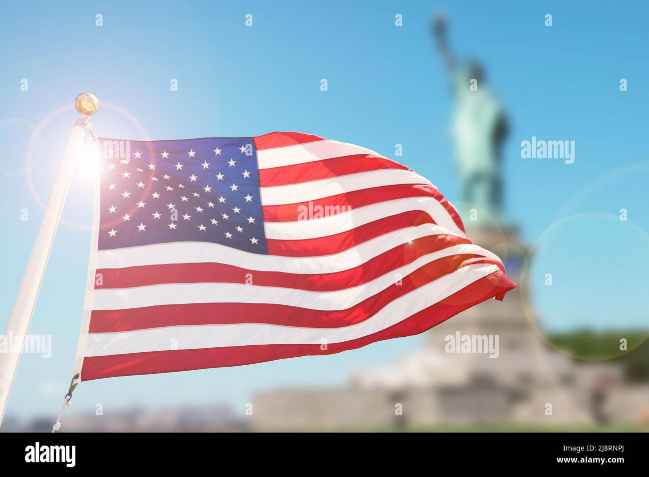 American flag on blurred statue of liberty background for Memorial Day, 4th of July, Labour Day, Presidents Day, Independence Day. Stock Photo