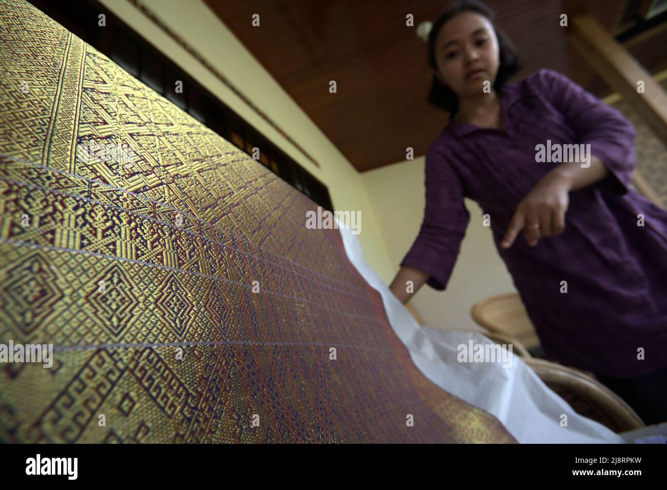 A high-profile songket fabric with golden yarn at Erika Rianti songket studio in Bukittinggi, West Sumatra, Indonesia. Stock Photo