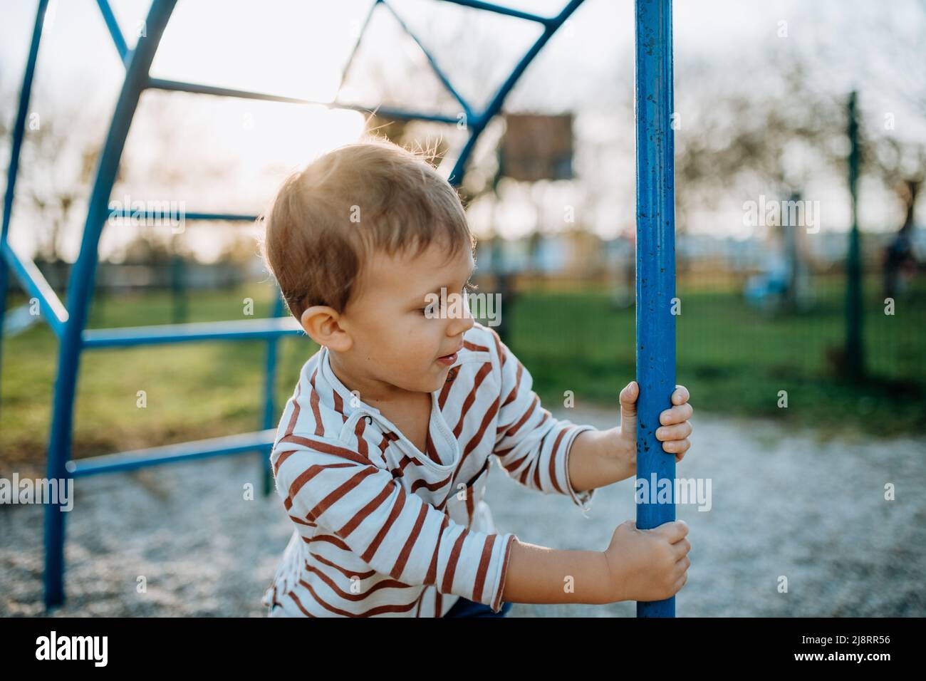 A little boy playing on outdoor playground Stock Photo - Alamy