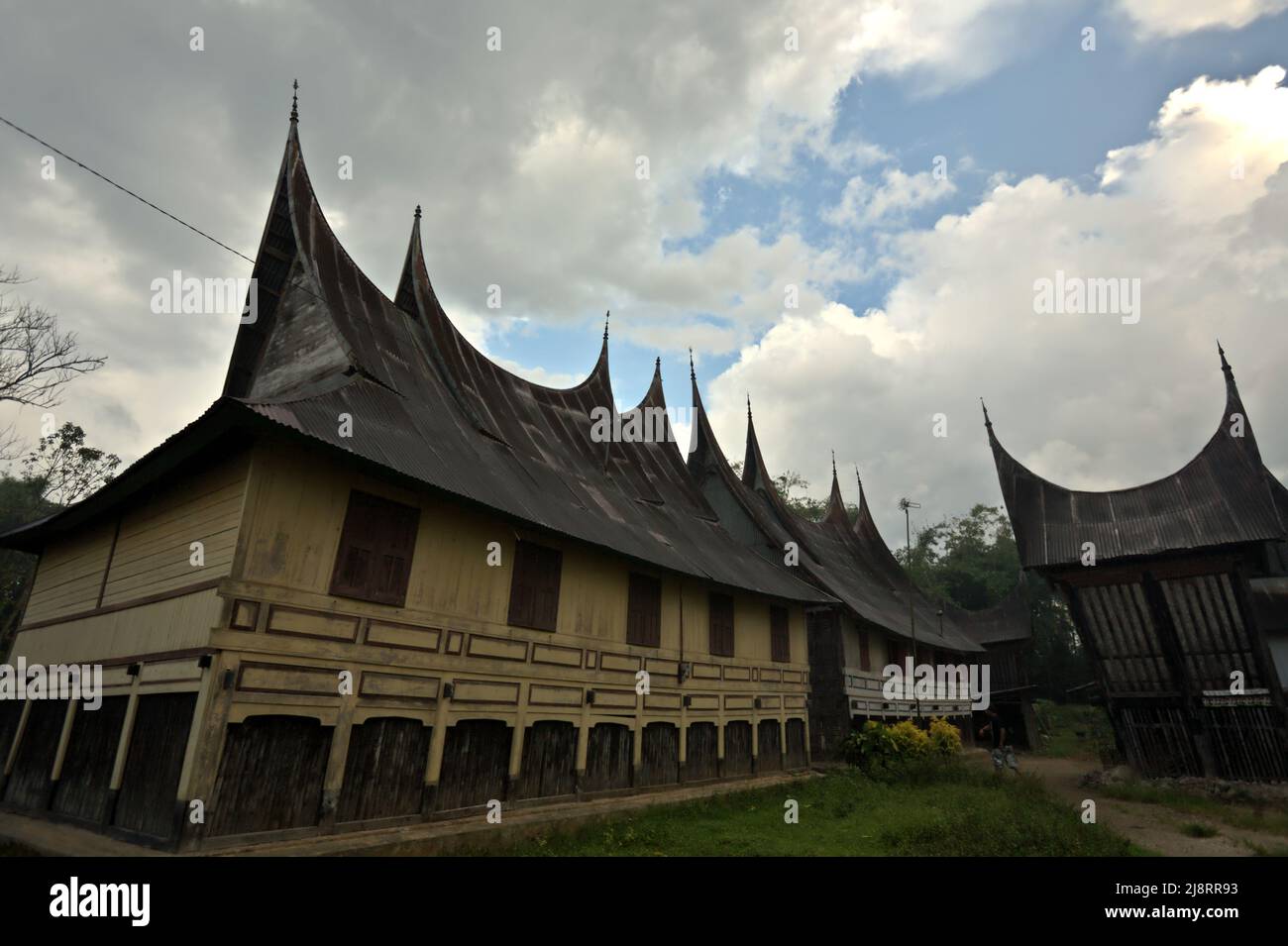 Traditional house of Minangkabau with water buffalo horn-shaped roof in Bukittinggi, West Sumatra, Indonesia. Stock Photo