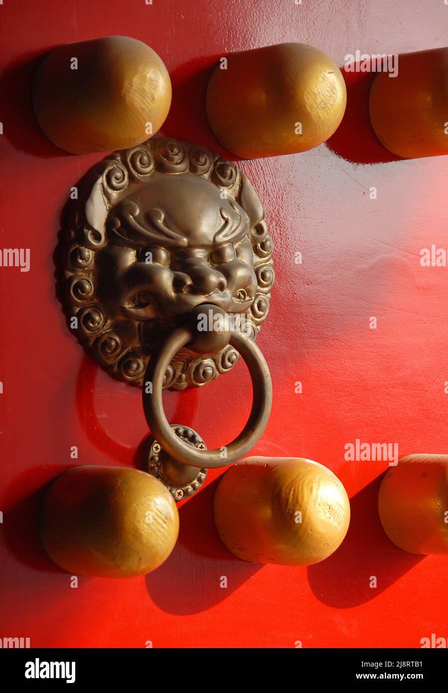 Detail of a traditional Chinese door at the Xiaoling Mausoleum of Ming Dynasty in Nanjing, Jiangsu Province, China. Red door with lion handle. Stock Photo