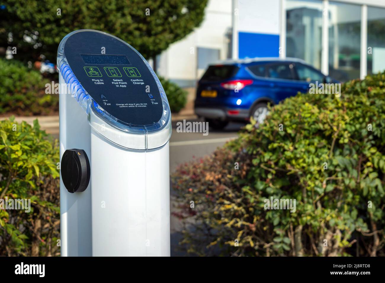 Electric vehicle recharging point sign post in England UK Stock Photo ...
