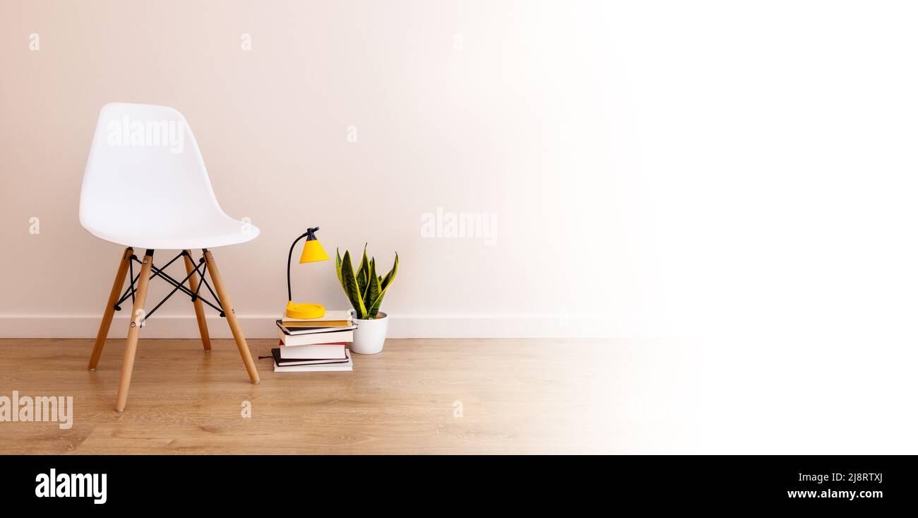 banner with copy paste, white background. Empty chair next to books ...