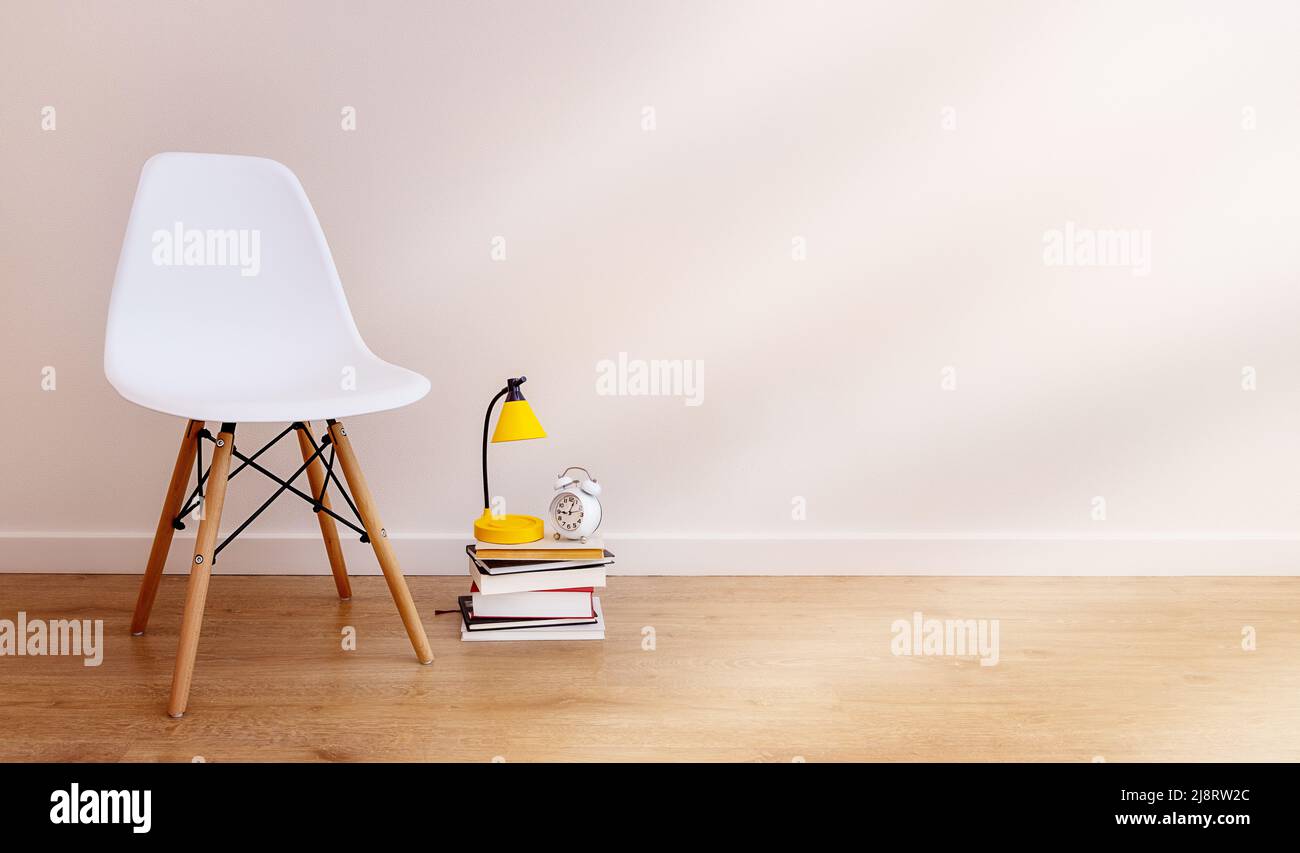 banner with copy paste, white background. Empty chair next to books ...