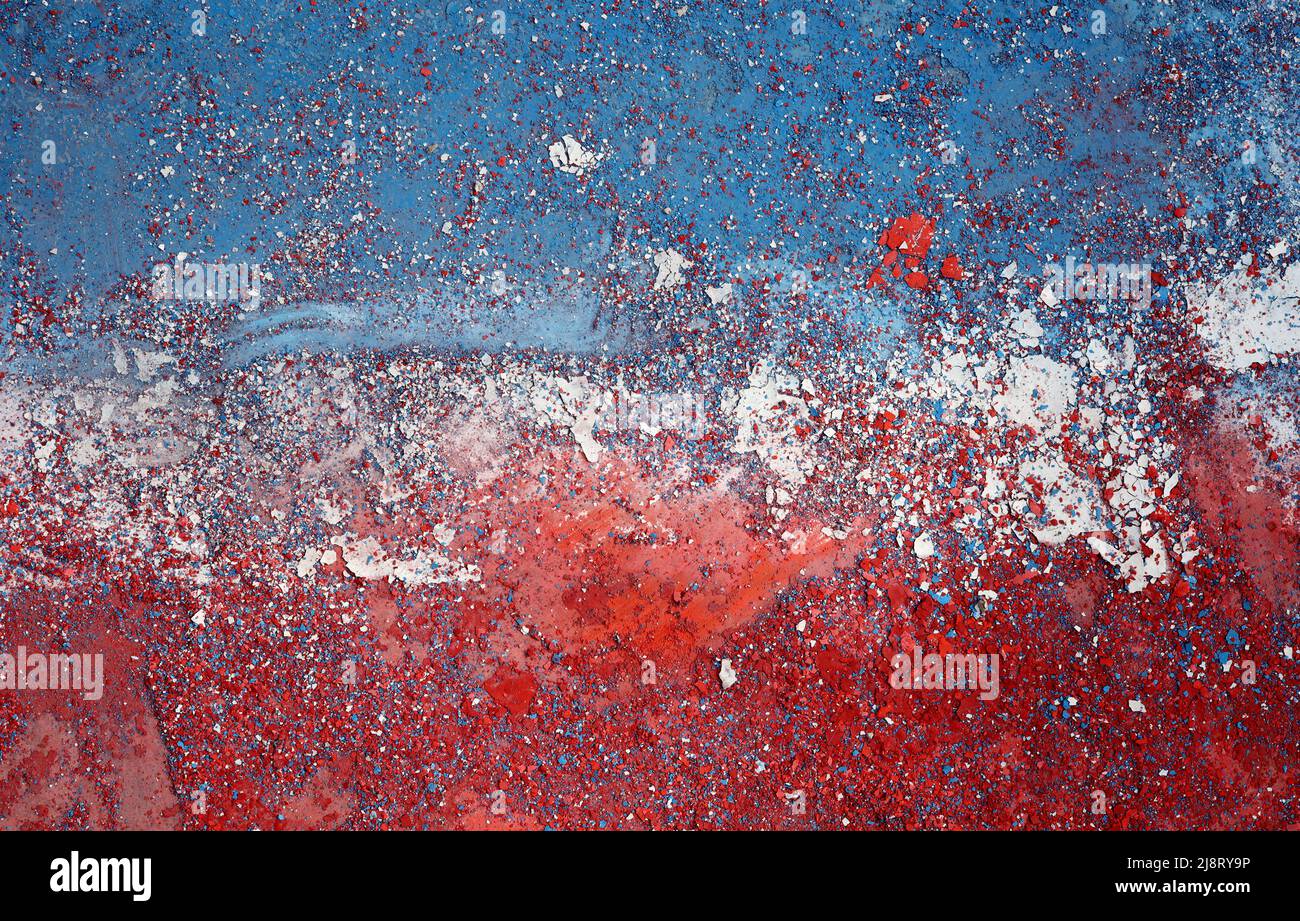 Colorful paint peeling on stone wall Stock Photo