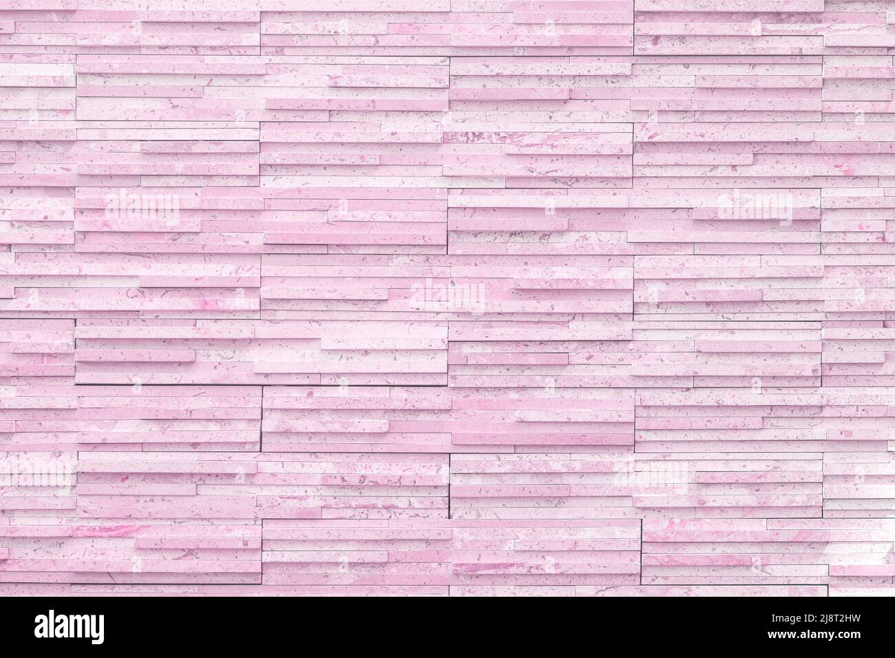 the background masonry of the wall is a narrow long brick tile modern, pastel color, light pink. cherry red. Stock Photo