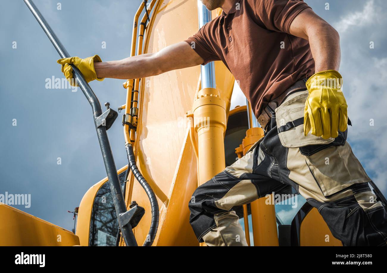 Professional Caucasian Excavator Operator Getting Ready for a Dirt Move