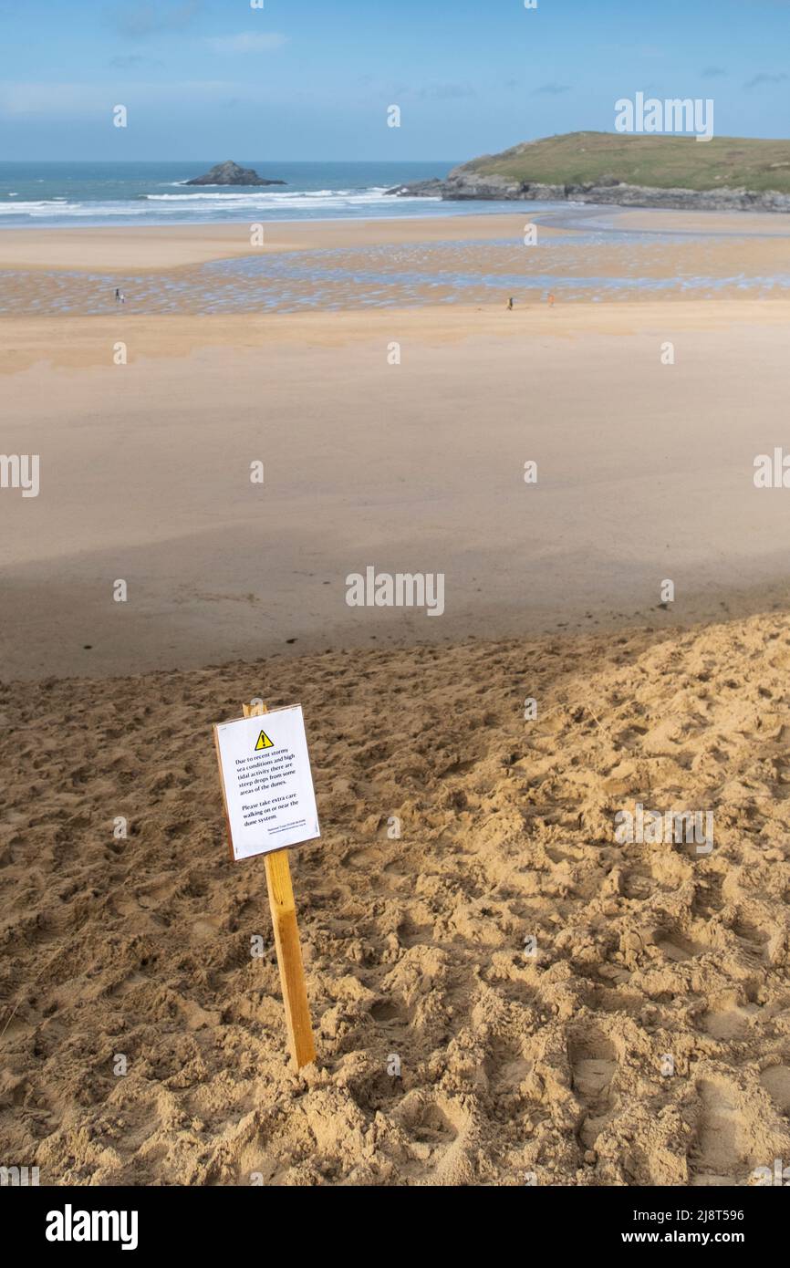A safety warning sign on the sand on the fragile delicate Rushy Green sand dune system at in Newquay in Cornwall. Stock Photo