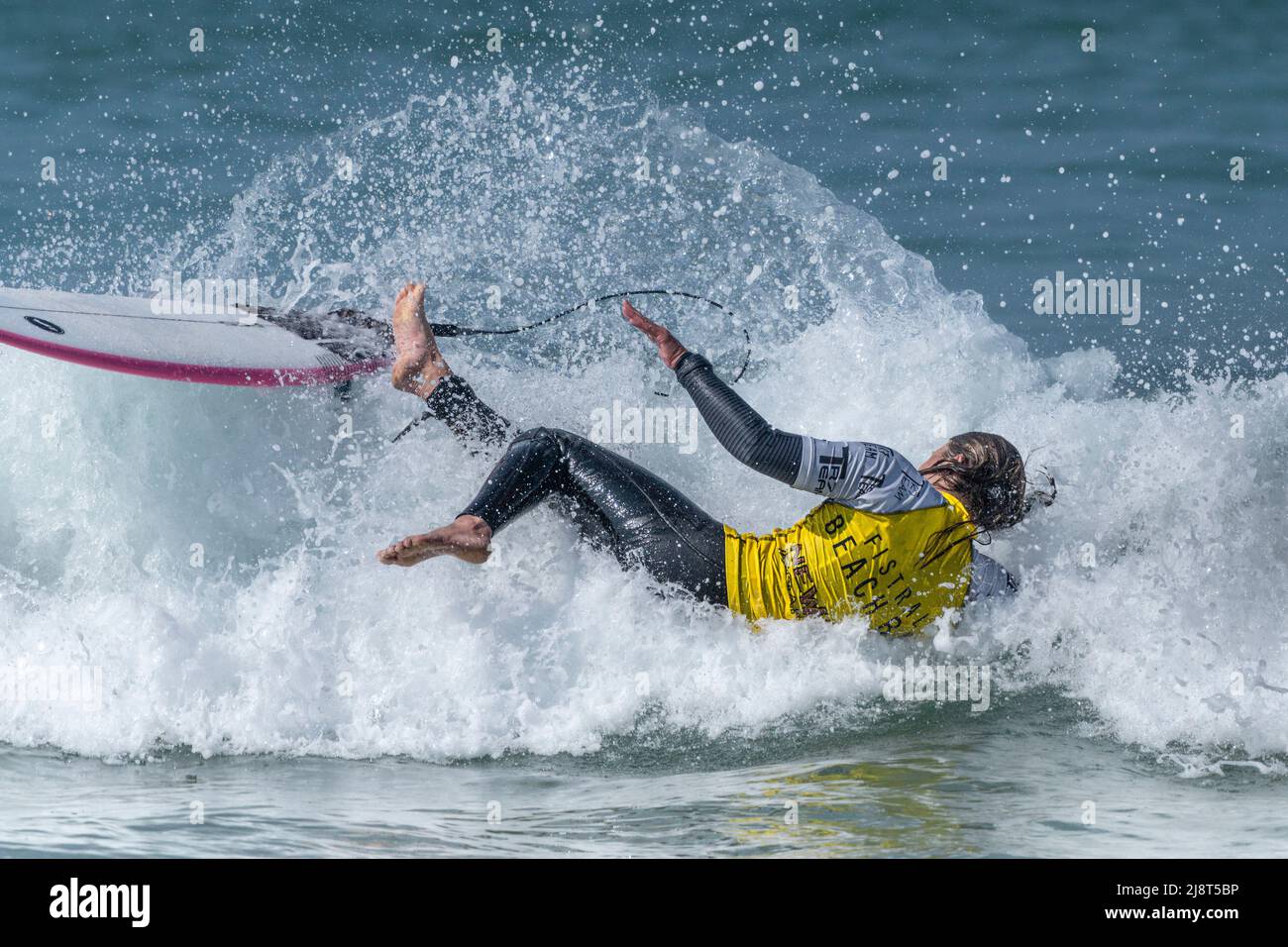 A surfer wiping out at Fistral in Newquay in Cornwall in the UK. Stock Photo