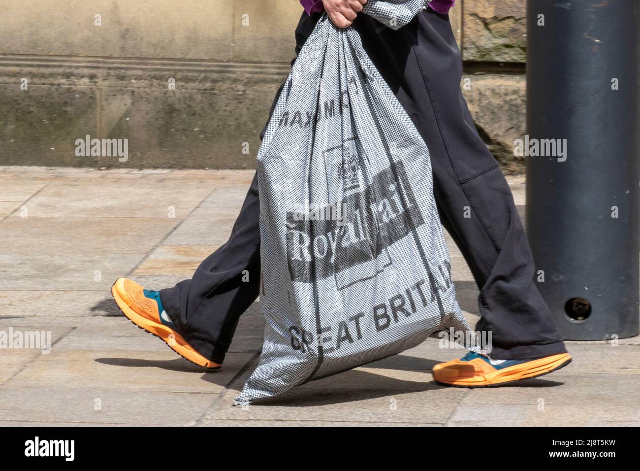 Great Britain Royal Mail delivery parcel sack, being carried by mail man, in Fishergate Preston, UK Stock Photo