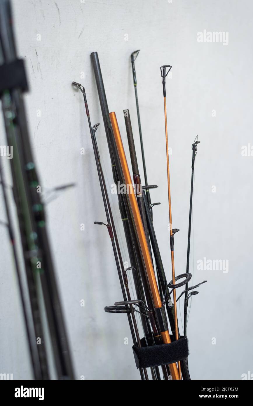 Close up fishing rods stand on wooden chair Stock Photo