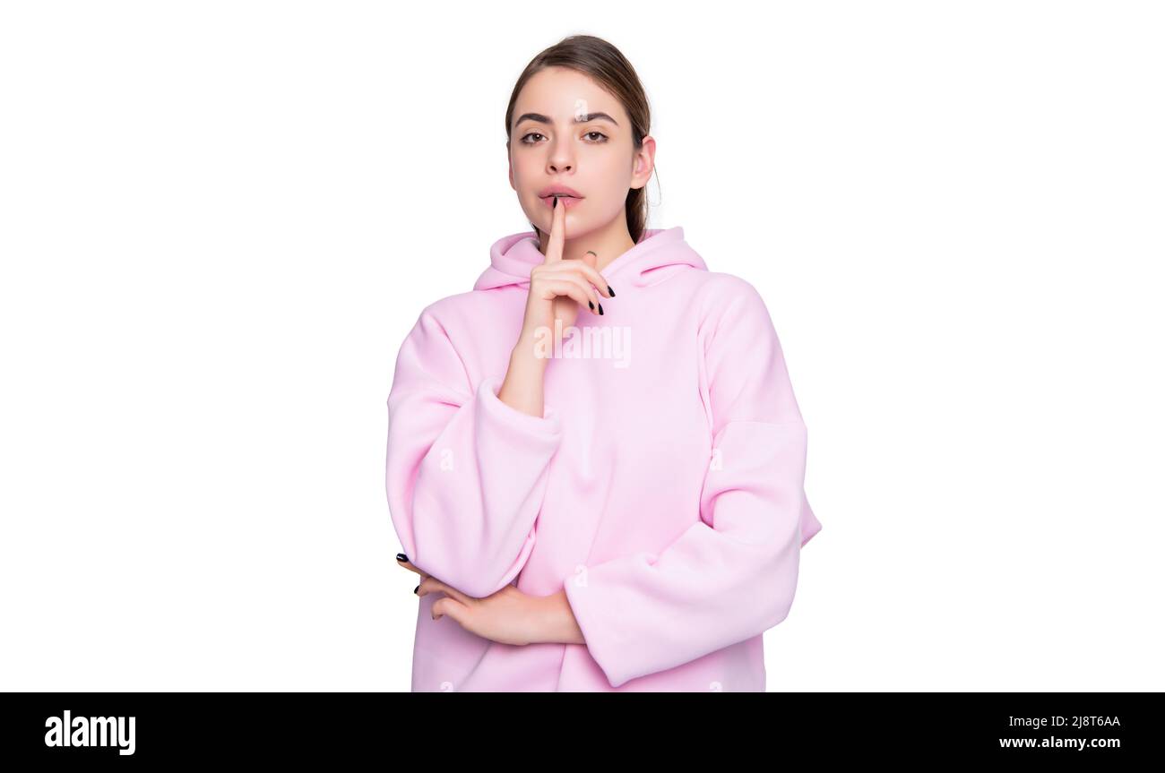 young girl in pink hoodie isolated on white background. keep secret Stock Photo