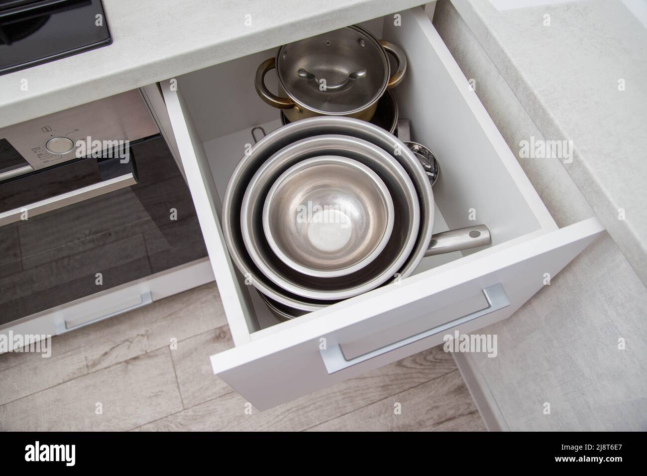 Modern drawers in the kitchen for storing utensils. Kitchen making