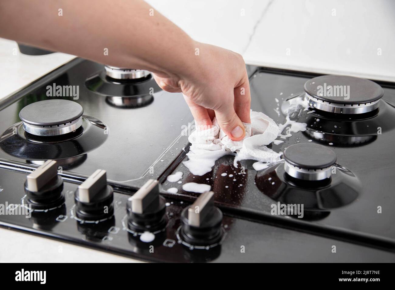 Cleaning and maintaining a gas hob. Degreasing, cleaner, closeup Stock