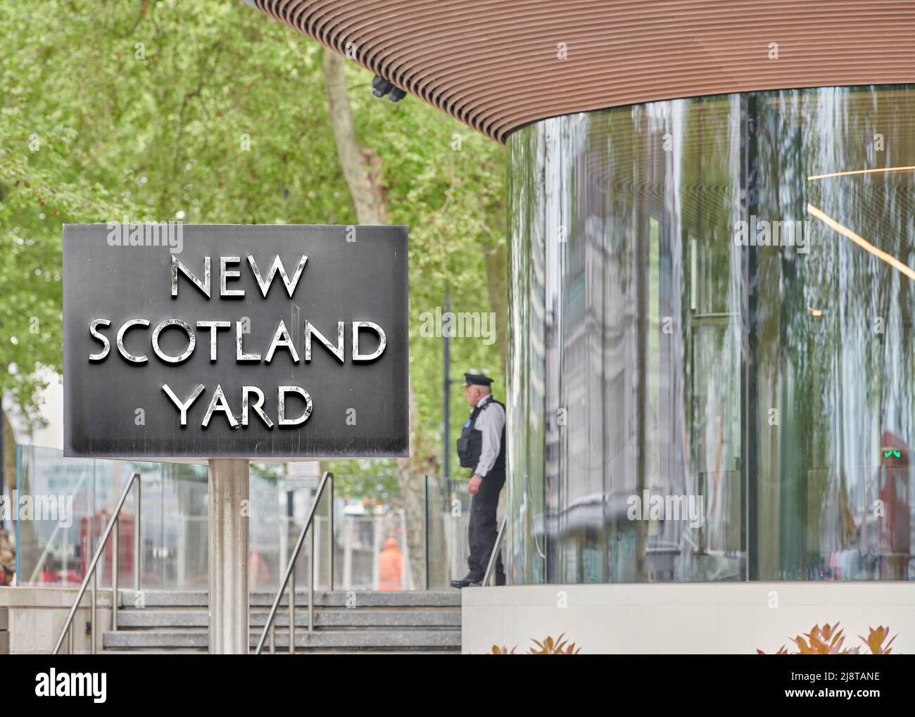 Police officer outside New Scotland Yard, headquarters of the