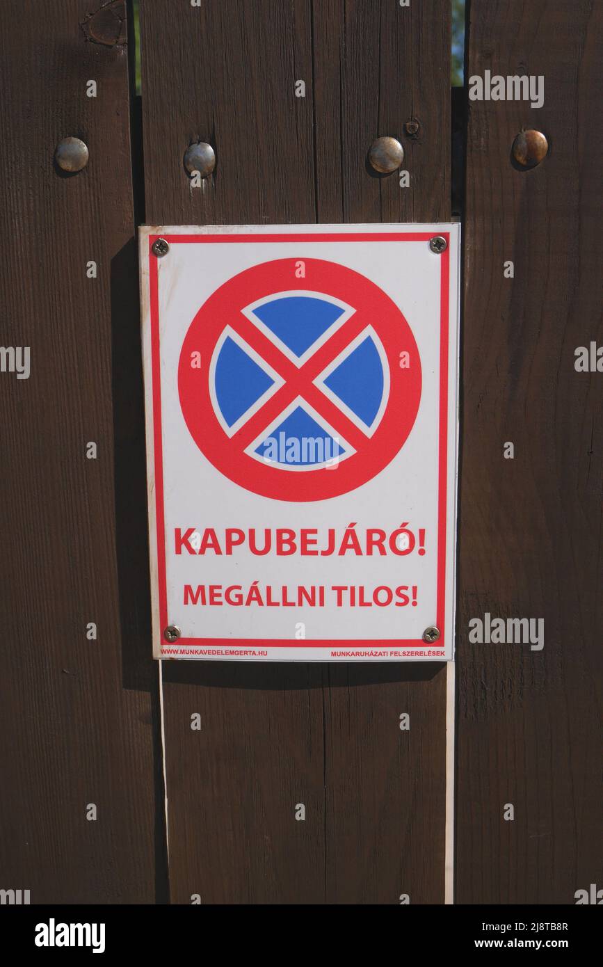 Sign in Hungarian, kapubejaro megallni tilos, no parking in front of the gate, Szigethalom, Hungary Stock Photo