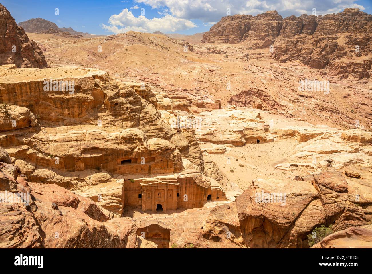 Landscape of Wadi Farasa canyon and view from above to the ancient tomb of Roman soldier and funeral ballroom carved in sandstone rock, Petra, Jordan Stock Photo