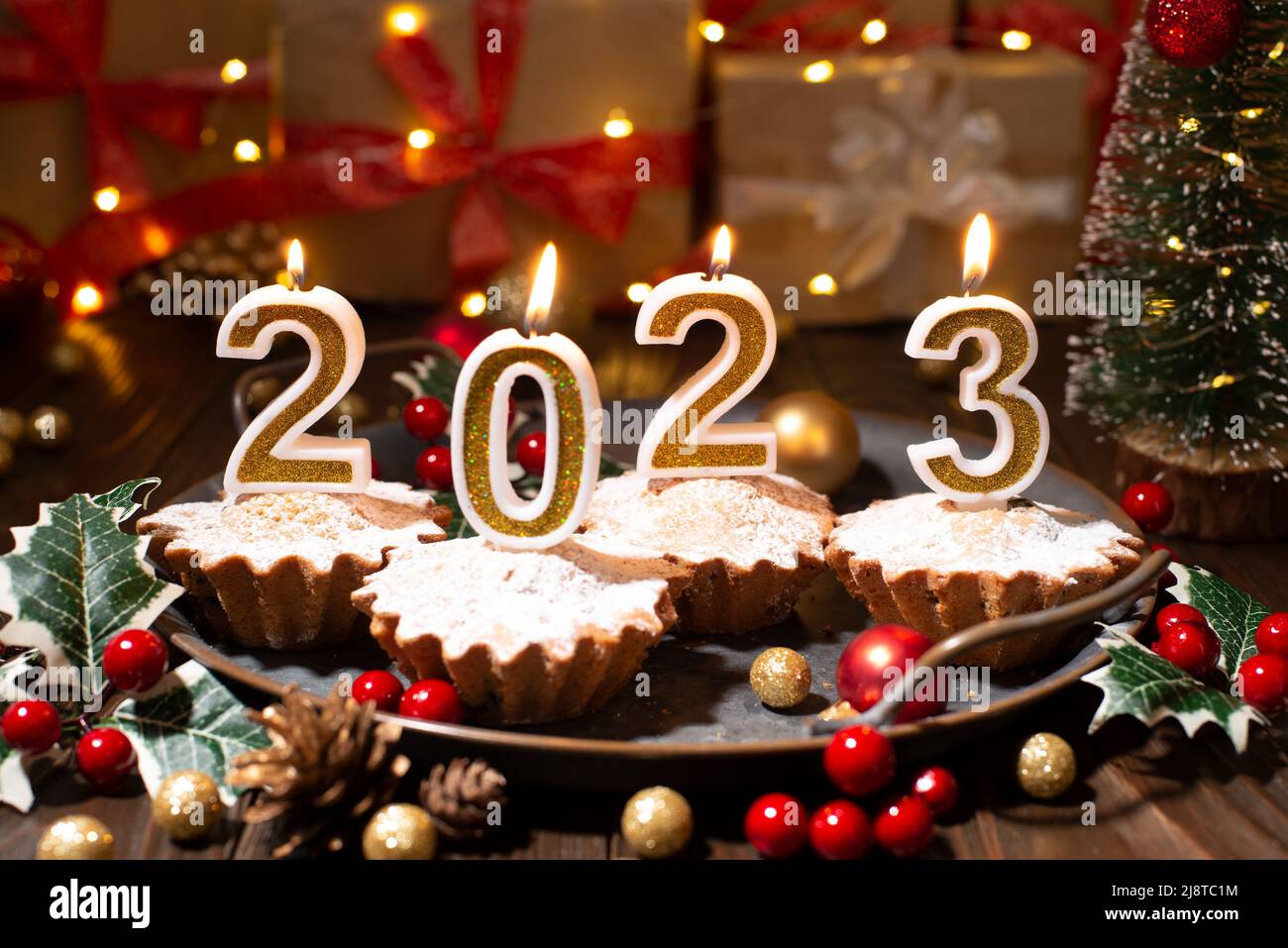 Food tray with cupcakes new year candles and christmas decorations Stock Photo