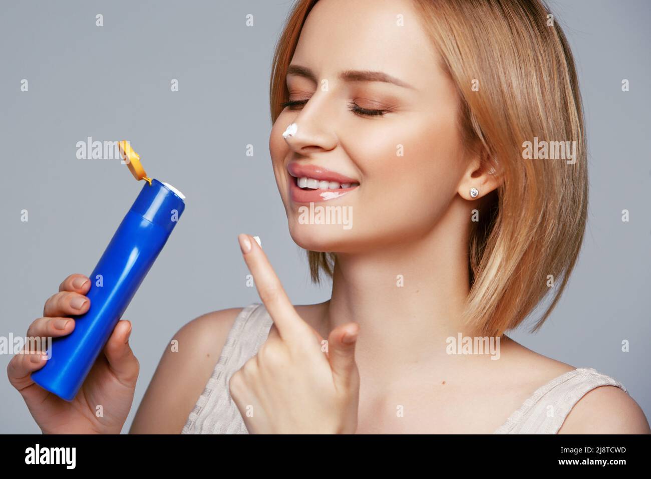 Woman holding bottle of suntan lotion hi-res stock photography and images -  Alamy