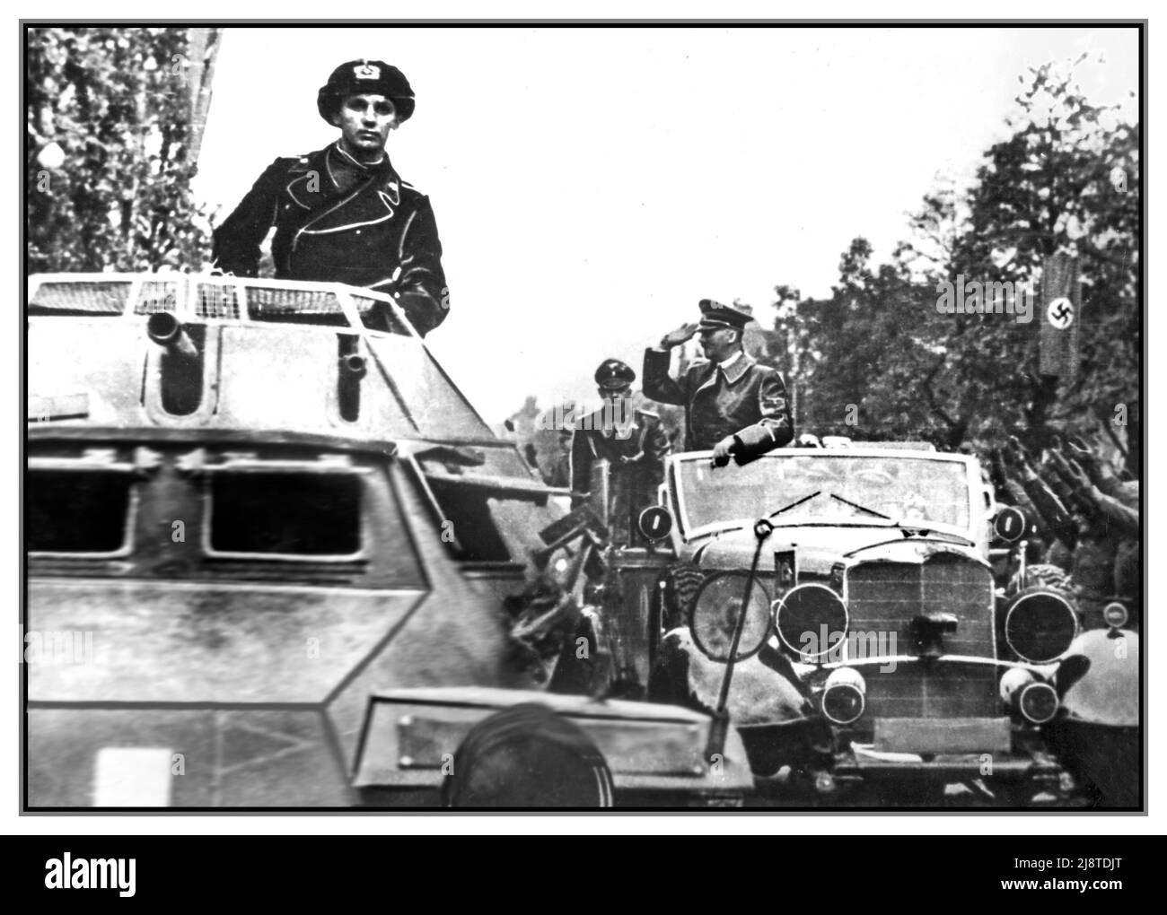 WW2 POLAND Adolf Hitler greets and salutes the Heil Hitler saluting soldiers from his half track Mercedes car. In the foreground, the SdKfz 222 armoured vehicle. Leichter Panzerspähwagen, with panzertruppen soldier standing. The Occupation of  Gdańsk Poland that started World War II 1939 Stock Photo