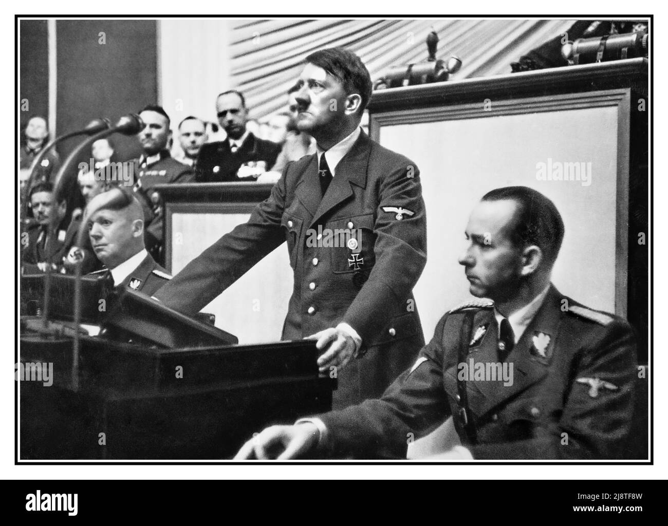 Adolf Hitler making his 1939 war speech to The Reichstag Berlin Nazi Germany De grosse Reichstag. 1939. Translation: The great Reichstag. 1939.  Address by Adolf Hitler, Chancellor of the Reich, before the Reichstag, September 1, 1939.  Hitler at the Reichstag, 1 September 1939. For this speech, Hitler wore a field-grey military uniform, conforming with the Generalissimo rank he was assuming, rather than the brown Nazi Party uniform that he had worn for earlier speeches. 1 September 1939, the day of the German invasion of Poland. The speech served as public declaration of war against Poland Stock Photo