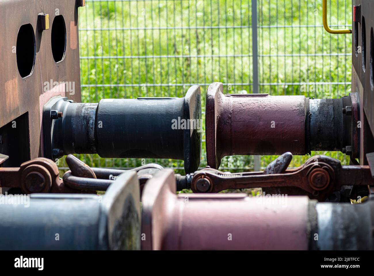 Chain coupler connecting freight wagons, large wagon buffers visible. Stock Photo