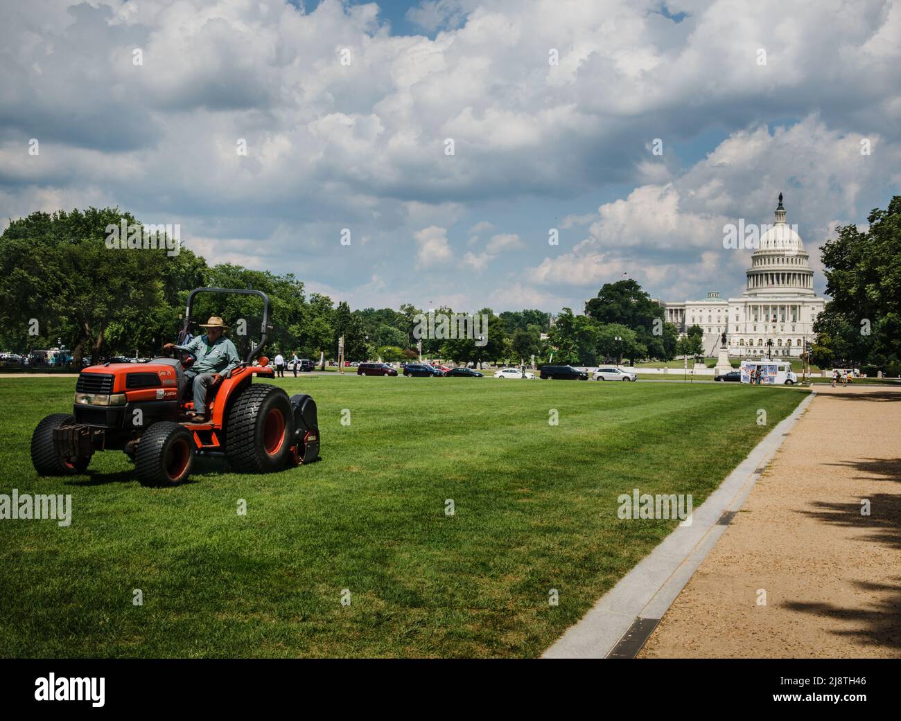 Man moving the lawn in front of the capital building Stock Photo