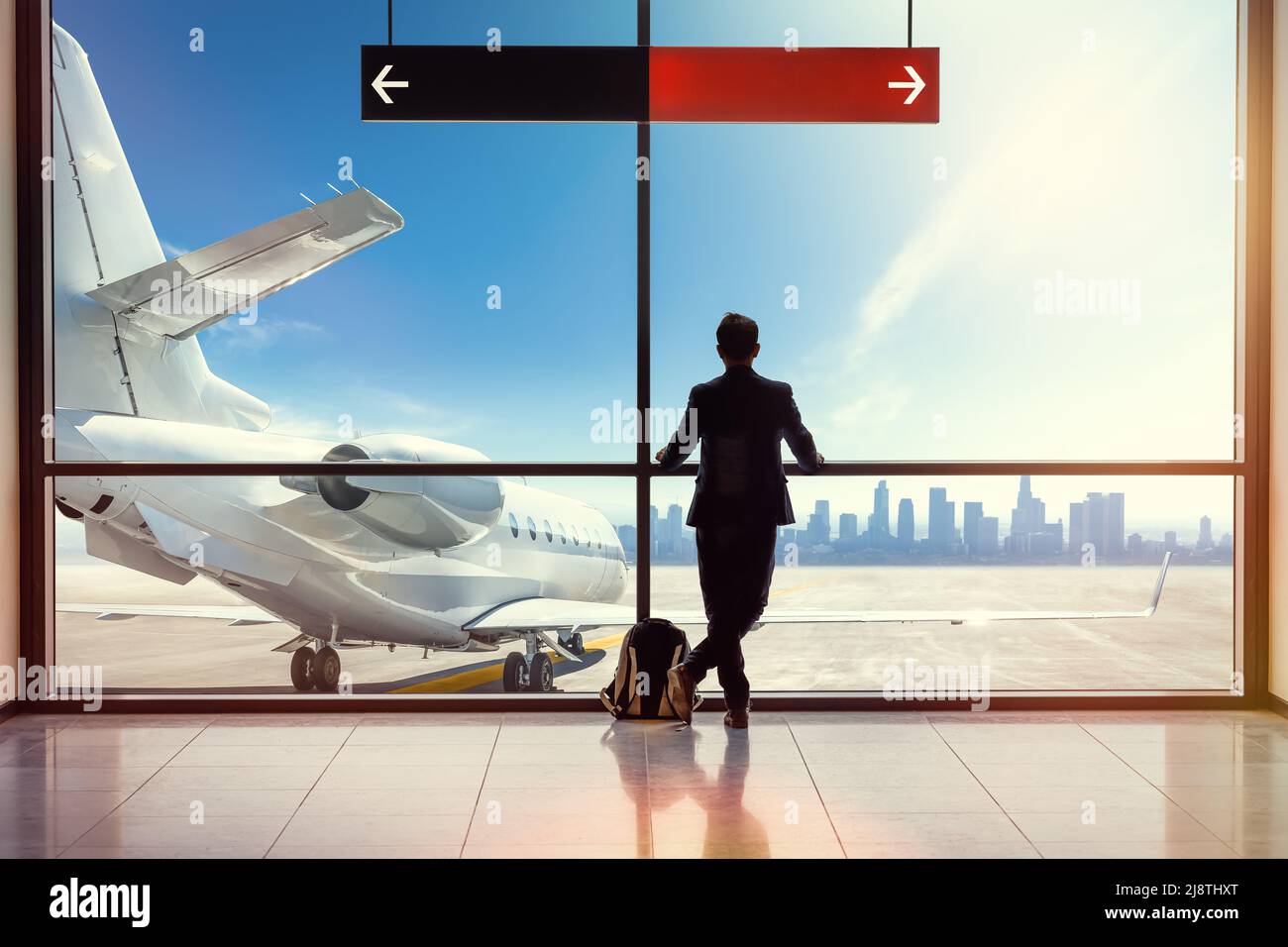 passenger at the airport is looking at a plane Stock Photo