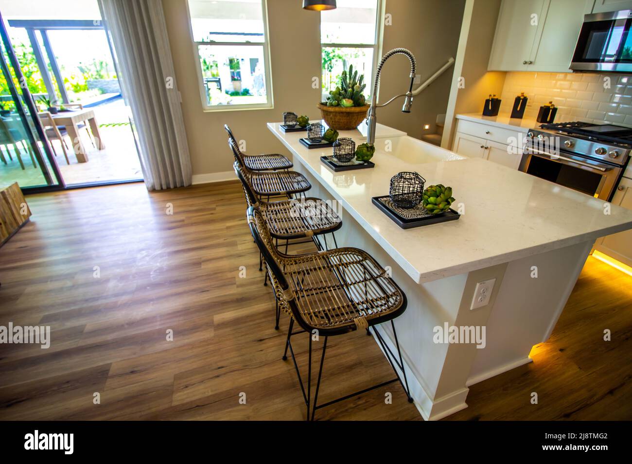 Modern Kitchen Island Counter Top With Place Settings And Bar Stools Stock Photo Alamy