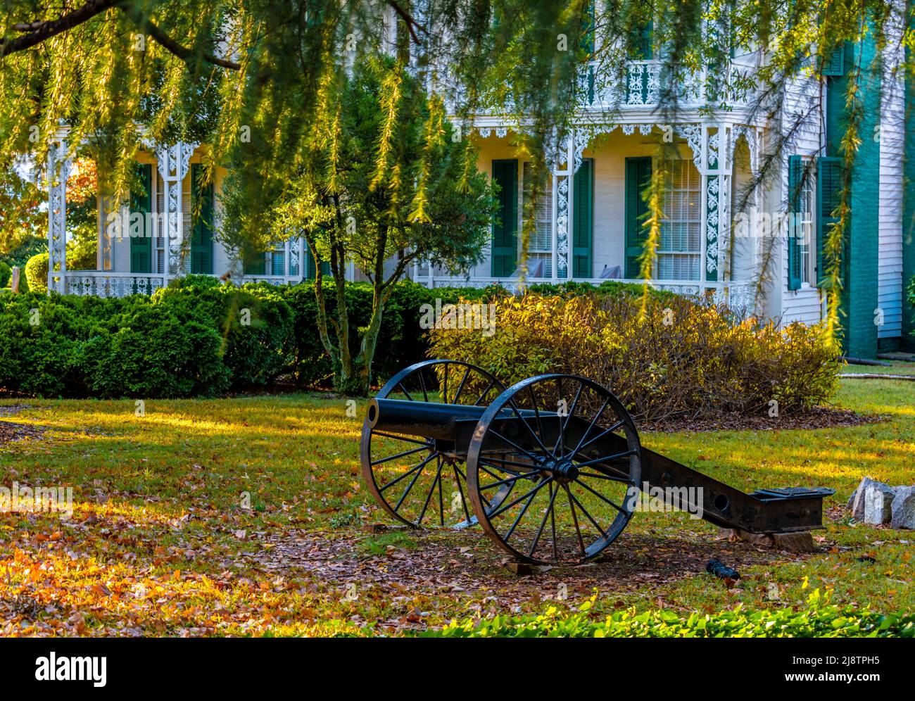 Exterior shot of antebellum Dr. Josephus Hall House in Salisbury, North Carolina with Spanish moss hanging down and a civil war canon on the lawn. Stock Photo