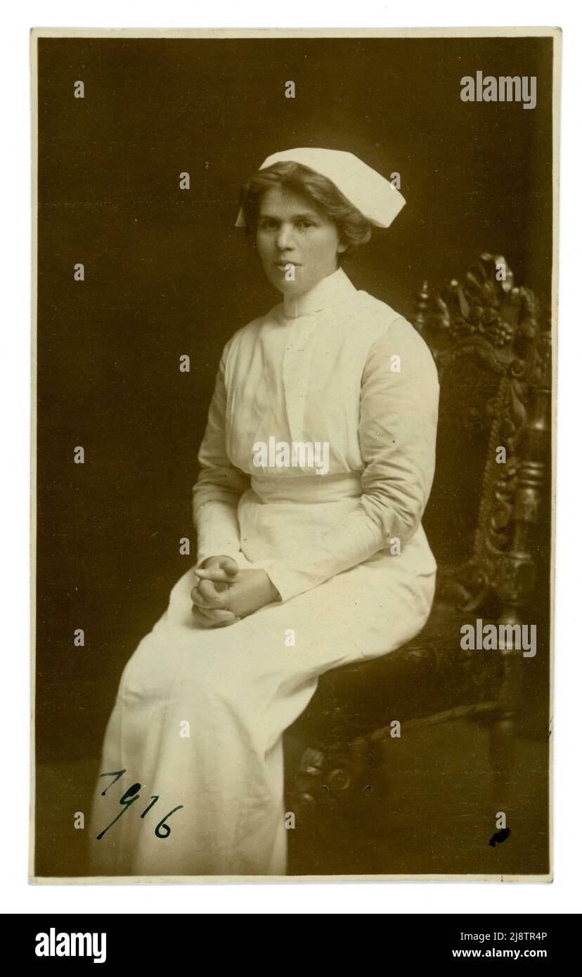 Original  WW1 era studio portrait postcard of an attractive nurse dated 1916 on the front, and with best love to Maud from Rose, Jan 1916 written on the reverse. From the studio of Emberson & Son, 12 Oxford St., London, U.K. Stock Photo