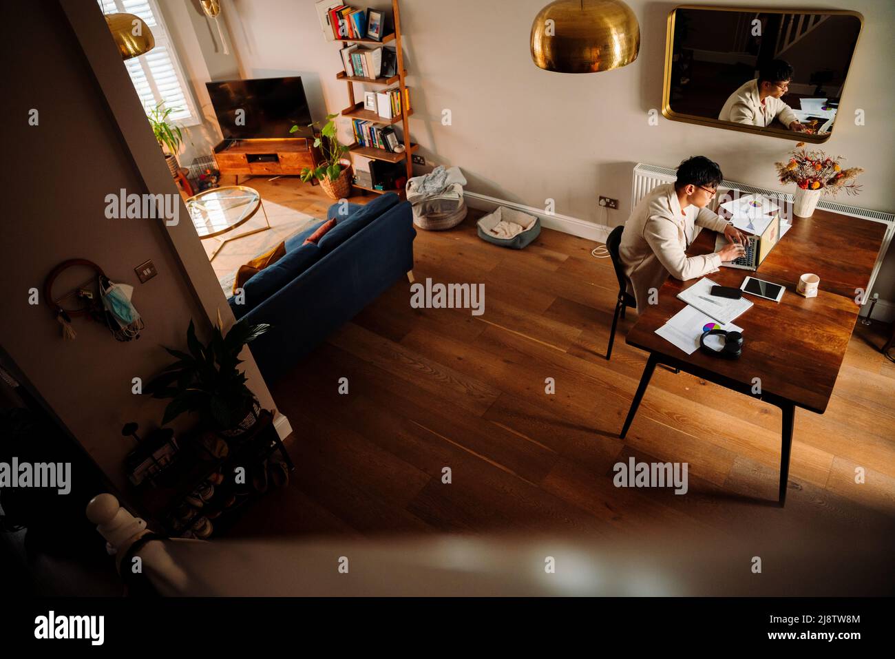 Asian male studying in apartment Stock Photo